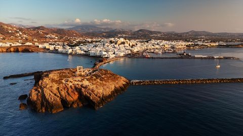 Naxos Chora and its harbour at dusk, with the Portara islet in front